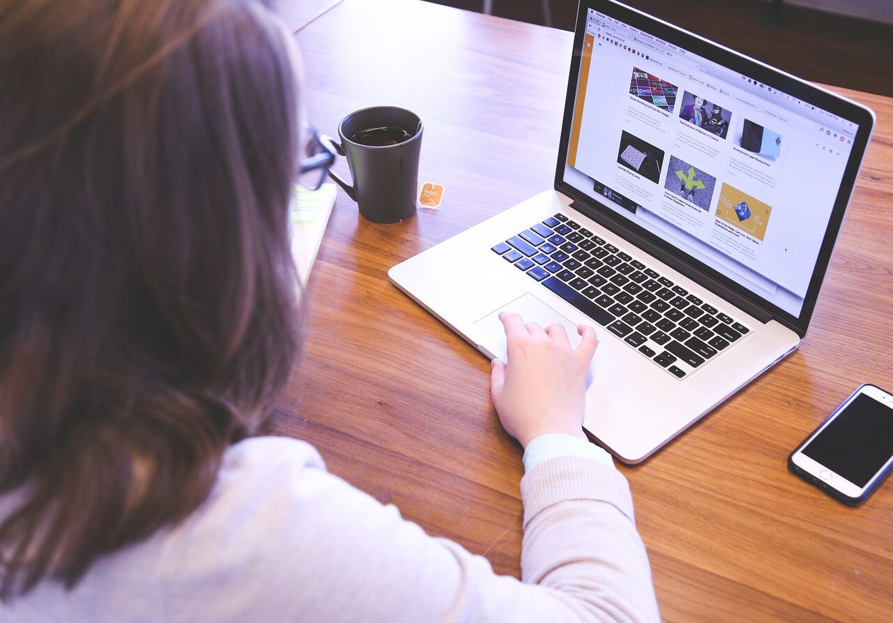 Woman and laptop on desk